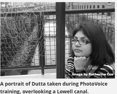 A portrait taken by Katherine Cox of Dr. Urmitapa Dutta taken during Photovoice training, overlooking a Lowell canal.